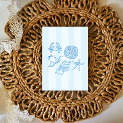 Rattan placemat with a decorative card featuring beach-themed illustrations on a white background.