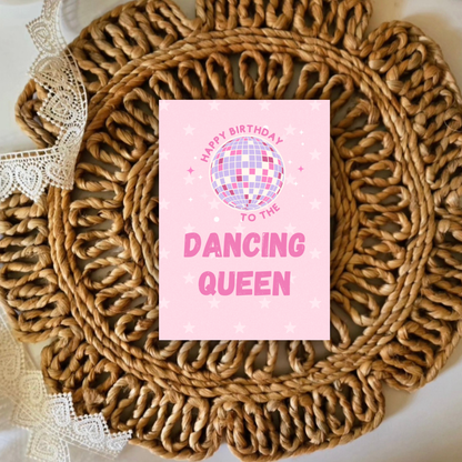 Pink birthday card with disco ball design on a woven mat