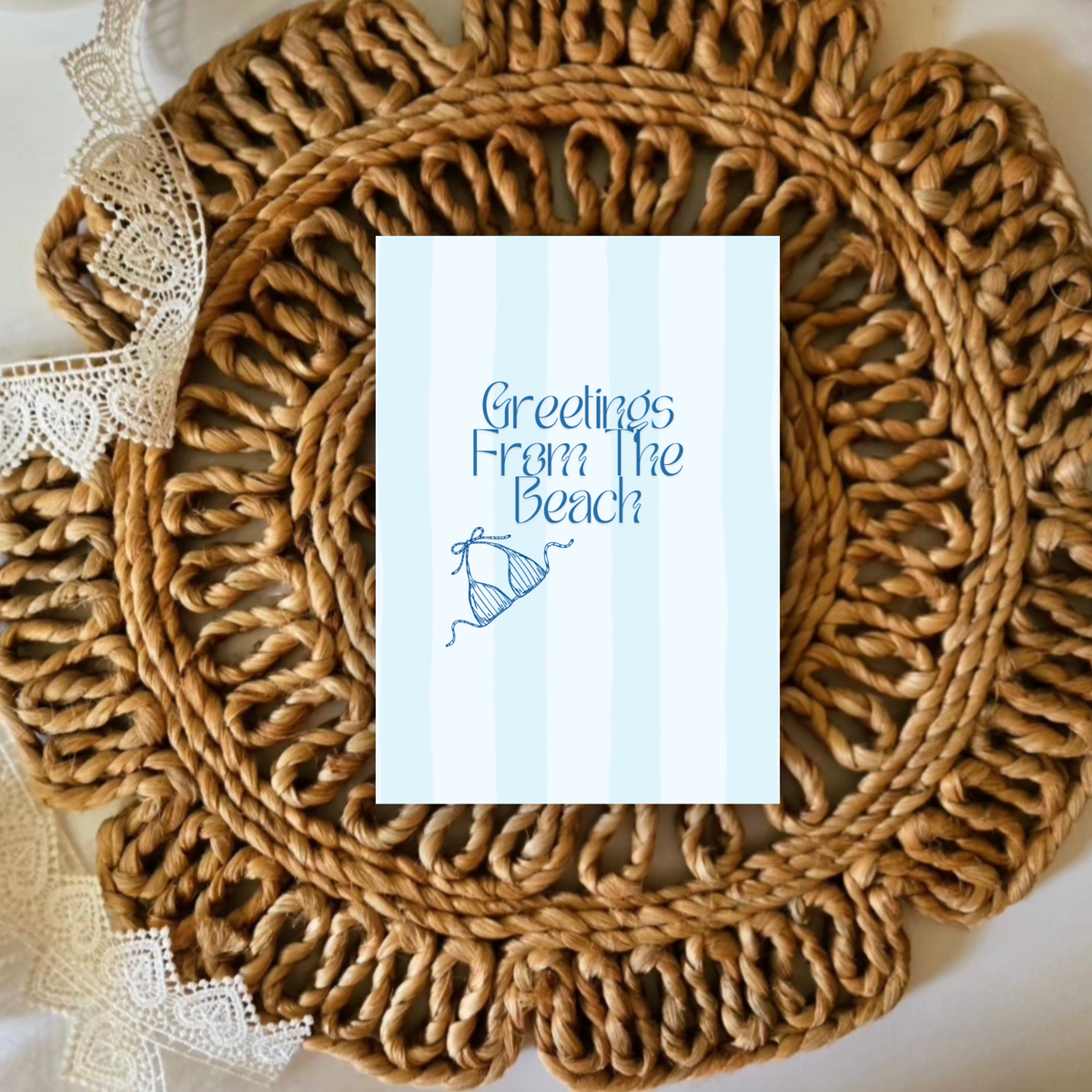 Woven placemat with a card reading 'Greetings from the Beach' on a white background