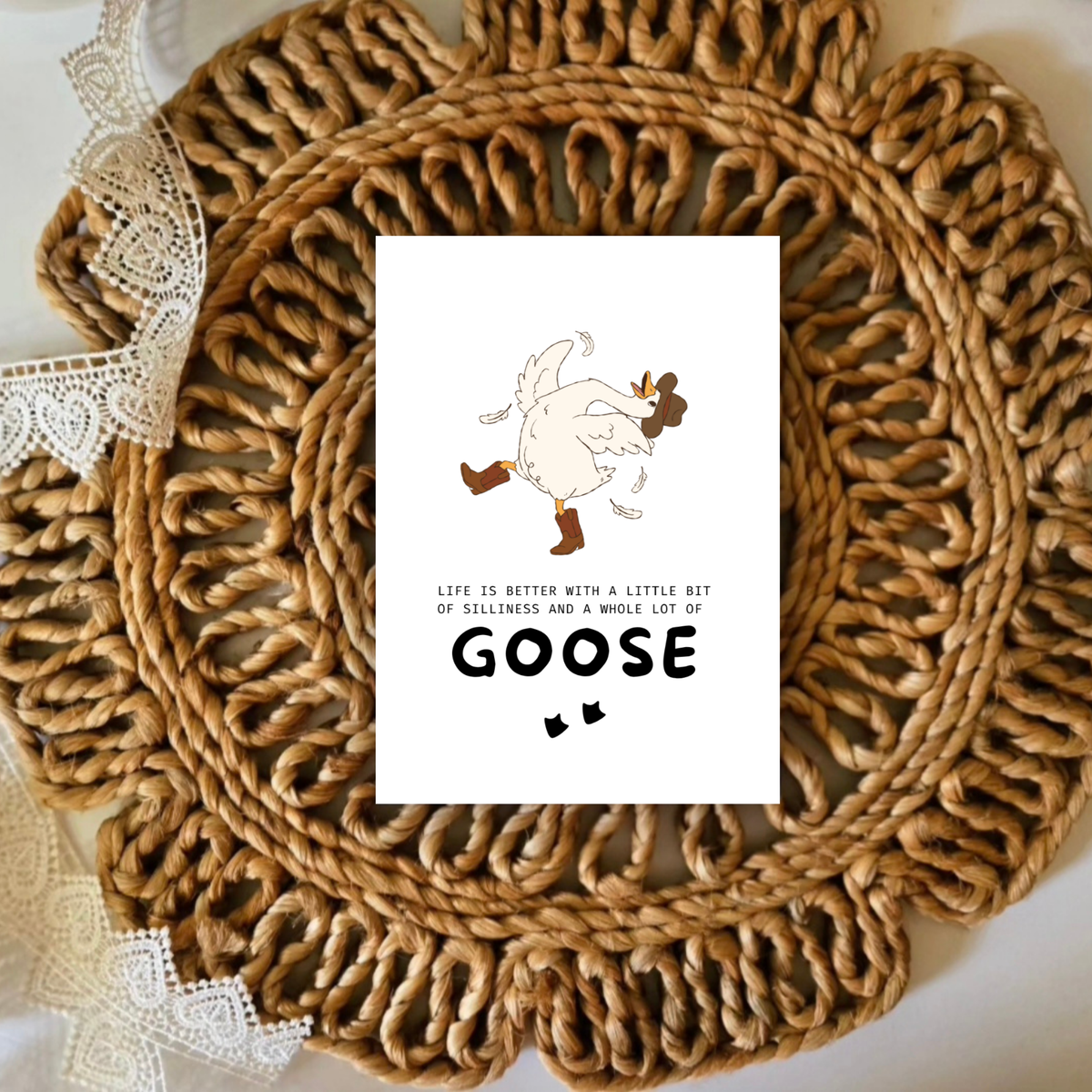 Woven placemat with a humorous card featuring a goose illustration and text.