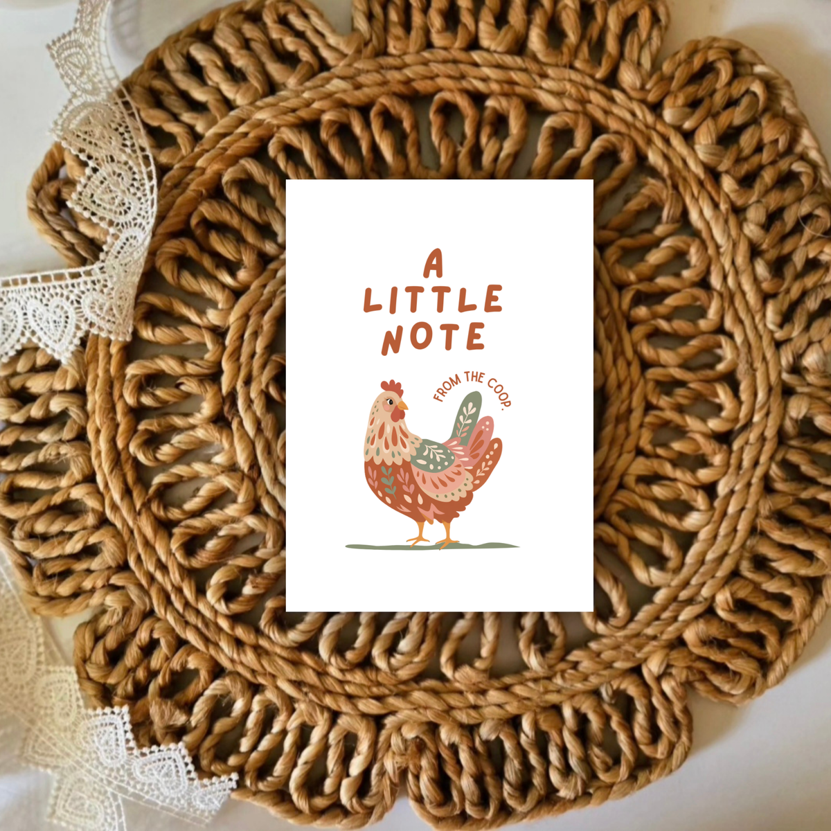 Woven placemat with a card featuring a rooster illustration and text on a white background